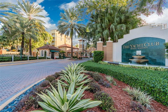 Front view of a multi-story residential building with a welcoming entrance and lush landscaping.