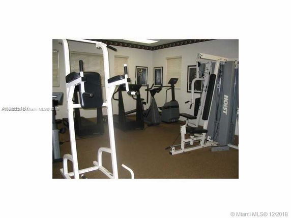 Indoor gym area with exercise equipment.