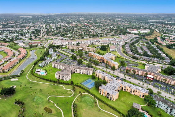 Aerial view of a residential complex with multiple buildings and green spaces.