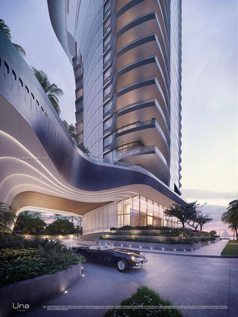 Front view of a modern high-rise building with a unique curved design and large glass windows.