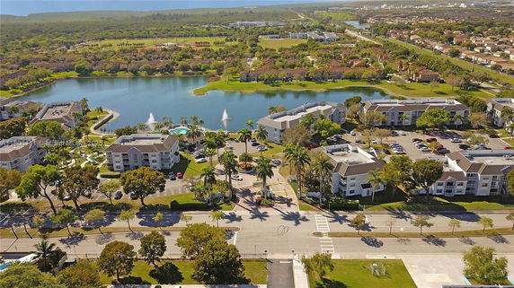 Panoramic view of residential buildings around a lake with a fountain.