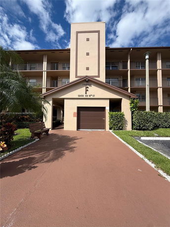Front view of a multi-story apartment building with balconies.