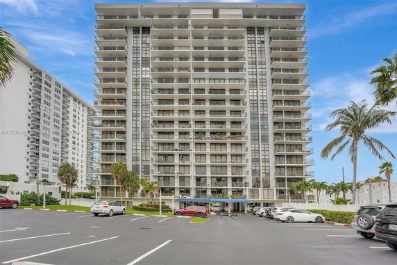 Front view of a multi-story residential building with balconies.