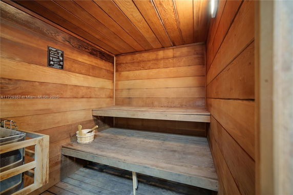 Interior view of a wooden sauna room with two levels of benches.