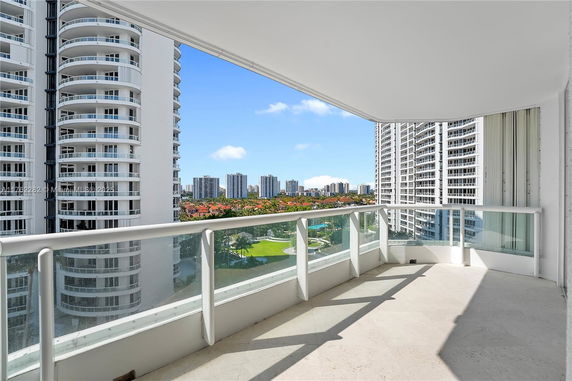 Balcony view of surrounding high-rise buildings and landscaped areas.