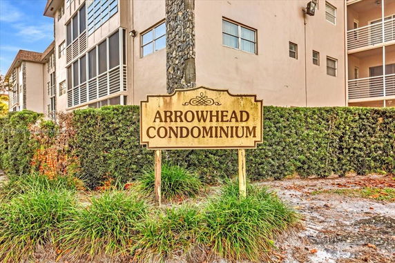 Front view of a condominium building with a sign reading 'Arrowhead Condominium'.