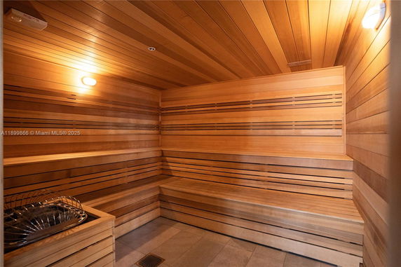 Interior view of a wooden sauna room with benches.