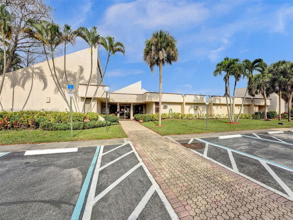 Front view of a single-story modern building with a unique roof design.