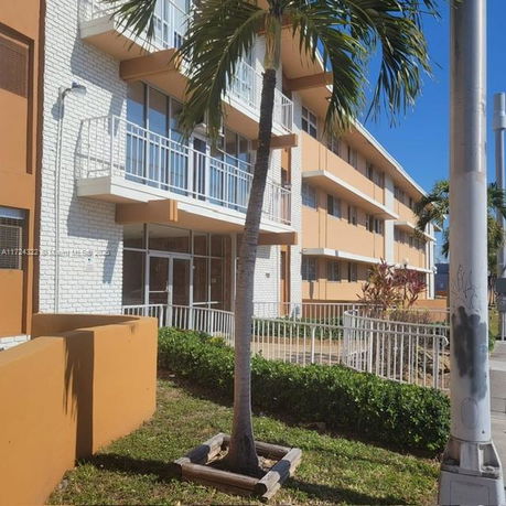 Front view of a multi-story building with balconies.