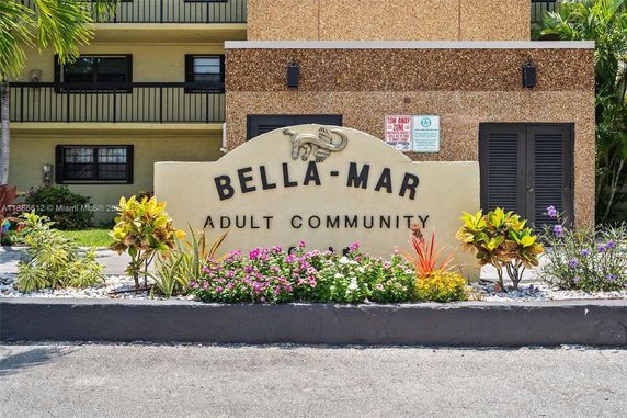 Front view of a building with Bella-Mar signage.
