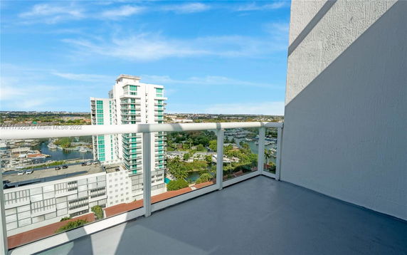 View from a balcony overlooking surrounding buildings and water