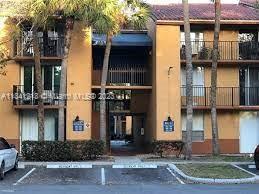 Front view of a multi-story apartment building with balconies.