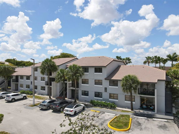 Front view of a two-story apartment building with parking area.