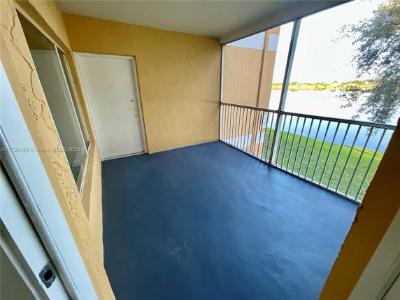Balcony with railing and view of a lake