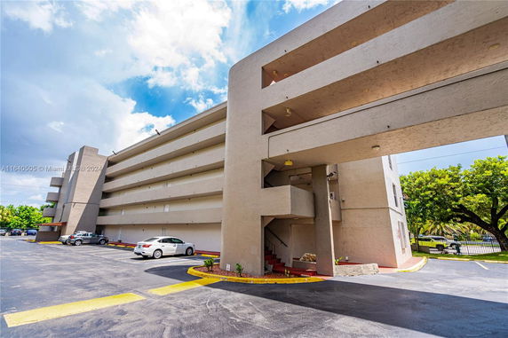 Parking area beside a multi-story building.