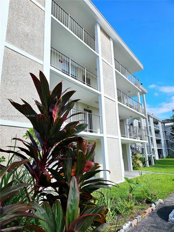 Front view of a multi-story apartment building with balconies.