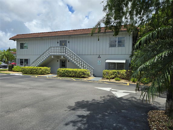 Front view of a two-story building with a staircase leading to the upper level.