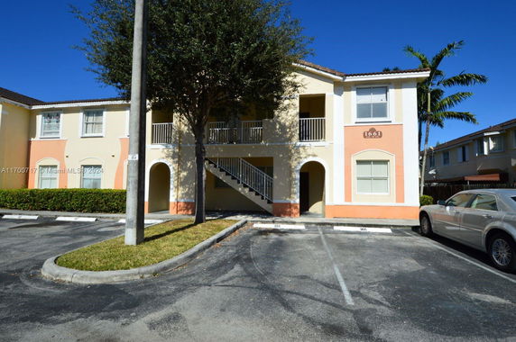 Front view of a two-story building with parking spaces.
