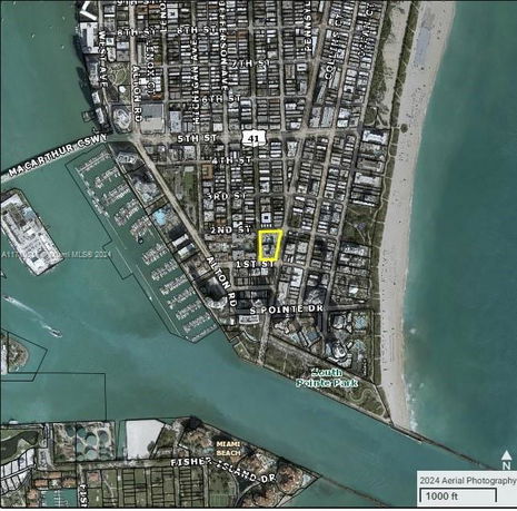 Aerial view of a coastal city layout with streets and buildings.