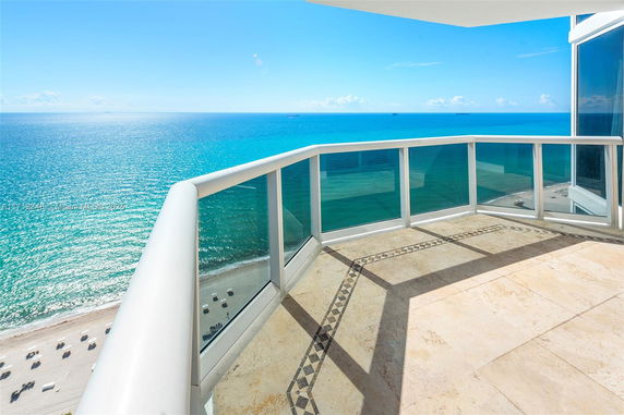 Panoramic view from a balcony overlooking the ocean.
