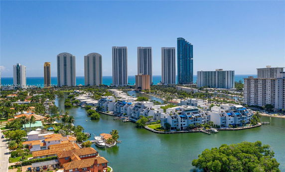Aerial view of a cityscape with high-rise buildings near a body of water.