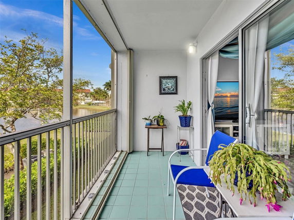 Balcony view with railing, potted plants, and scenic surroundings.