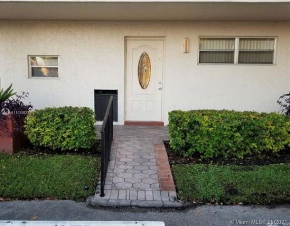 Front view of a house with a pathway leading to the entrance.