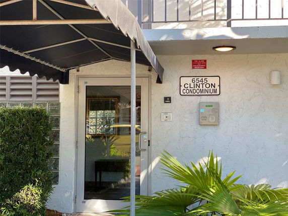 Front view of a condominium entrance with a covered entryway.