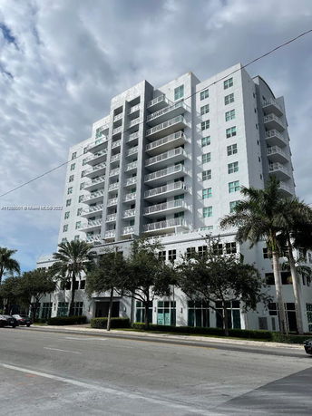 Front view of a multi-story residential building with balconies.