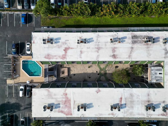 Aerial view of a building rooftop with several air conditioning units.