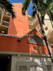 Front view of a multi-story building with orange and beige facade.