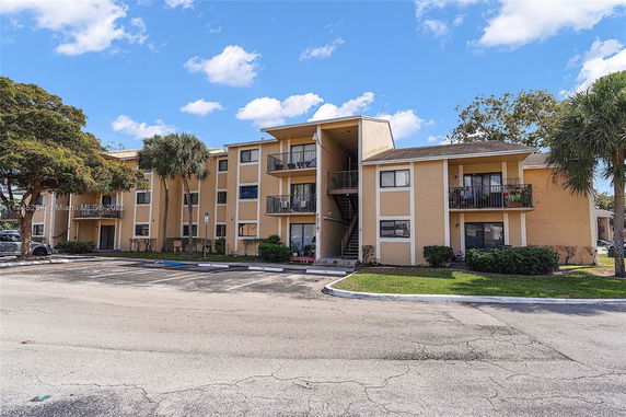 Front view of a multi-story residential building with balconies.