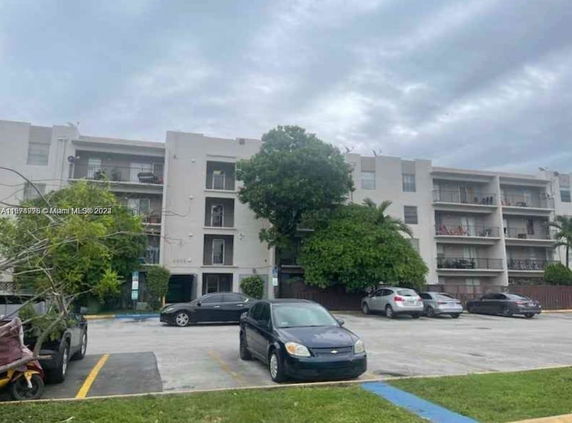Front view of a multi-story apartment building with balconies.