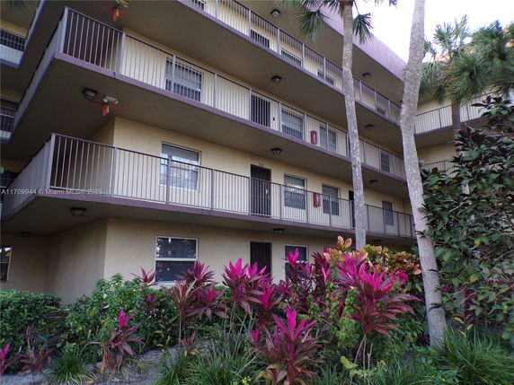 Front view of a multi-story residential building with balconies.