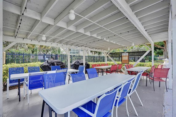 Outdoor covered patio area with tables and chairs.
