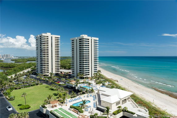 High-rise buildings near a sandy beach with a view of the ocean.