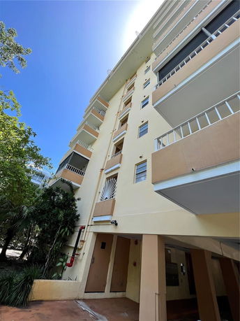 Front view of a multi-story residential building with balconies.
