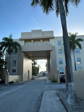 Front view of a multi-story building with an archway entrance.