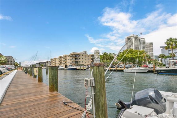 View of waterfront with boats and buildings in the background