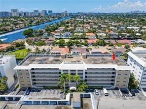 Aerial view of a multi-story building with a flat rooftop.