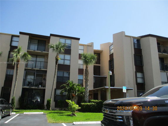 Front view of a multi-story residential building with balconies.