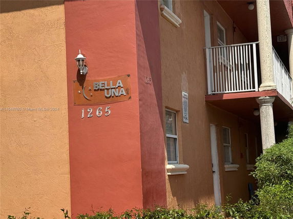 Front view of a building with a balcony and address number 1265.