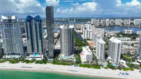 Panoramic view of multiple high-rise buildings along a beachfront area.