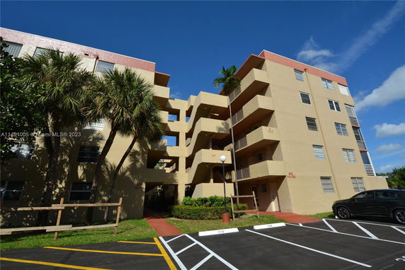Front view of a multi-story residential building with balconies.