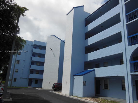 Front view of a multi-story residential building with blue accents.