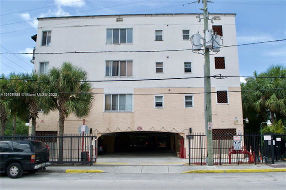 Front view of a multi-story building with parking entrance