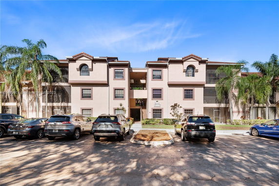 Front view of a multi-story residential building with multiple balconies.