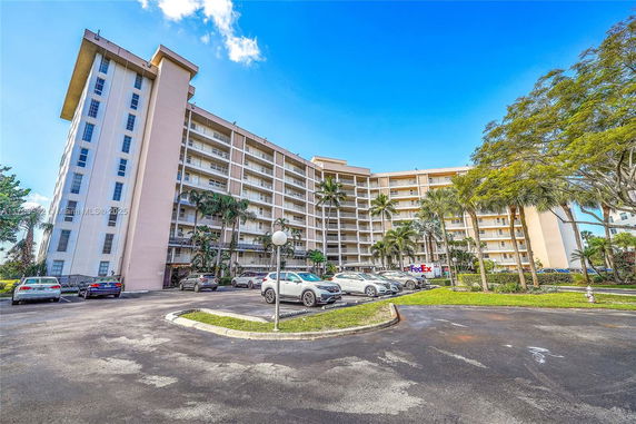 Front view of a multi-story residential building with balconies.