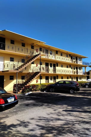 Front view of a multi-story building with external staircases.