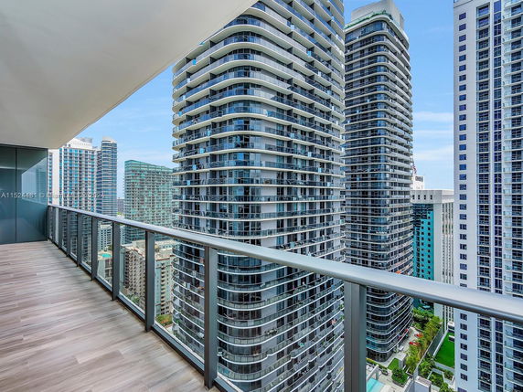 Panoramic view of high-rise buildings from a balcony.